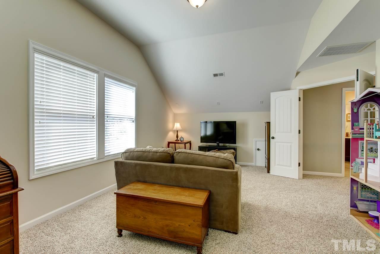4001 Red Grape Drive Raleigh, NC 27607 - Photo 22 of 25 a living room with furniture and a flat screen tv