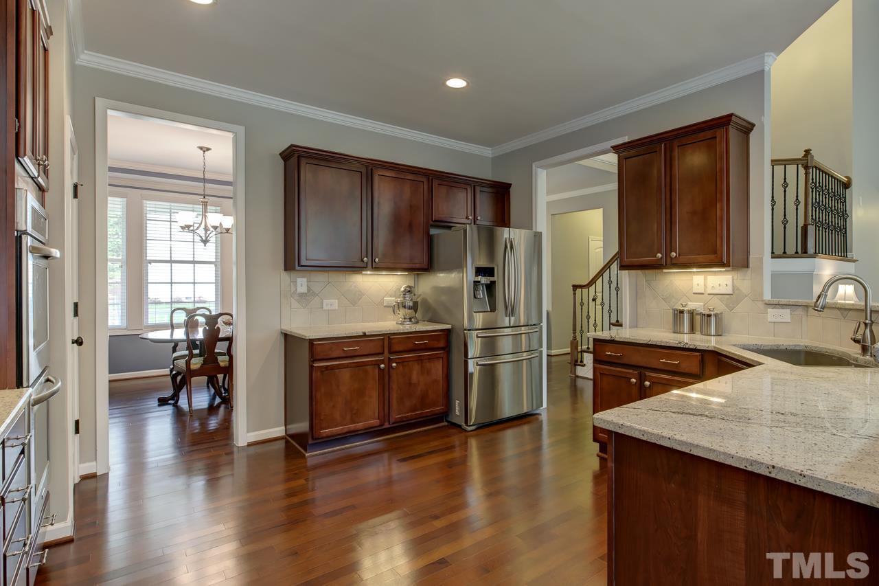 4001 Red Grape Drive Raleigh, NC 27607 - Photo 10 of 25 a kitchen with stainless steel appliances granite countertop a refrigerator stove top oven and sink