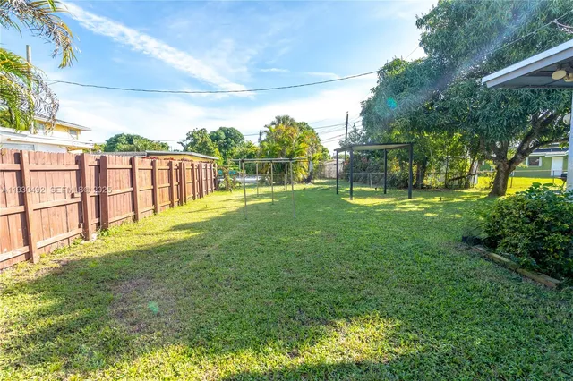 a view of yard with swimming pool and seating
