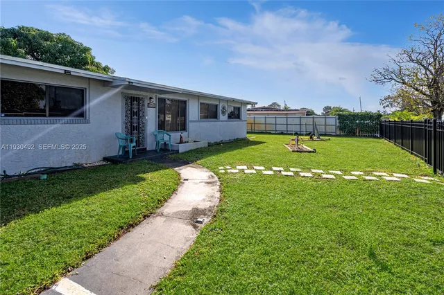 a view of a backyard with a garden and plants