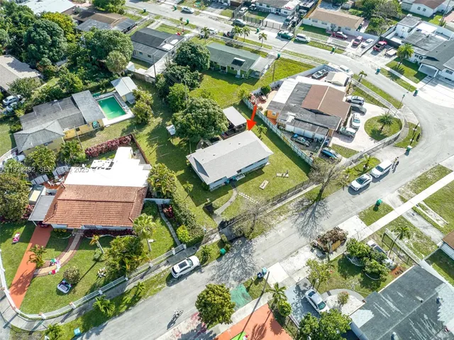 an aerial view of a house with a garden and swimming pool