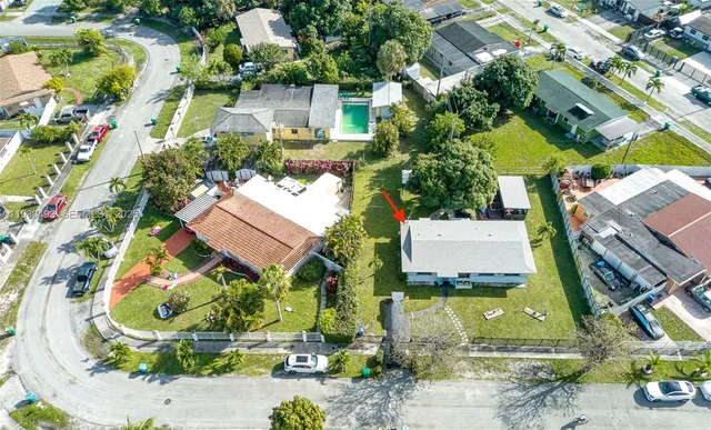 an aerial view of a house with a garden and swimming pool