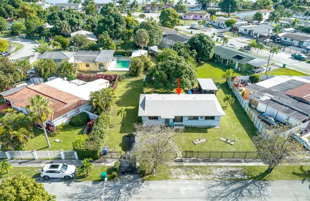 an aerial view of a house with a garden