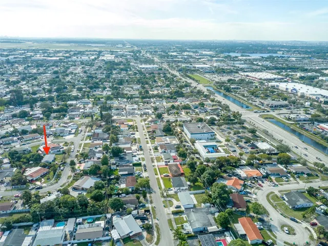 an aerial view of residential building with green space