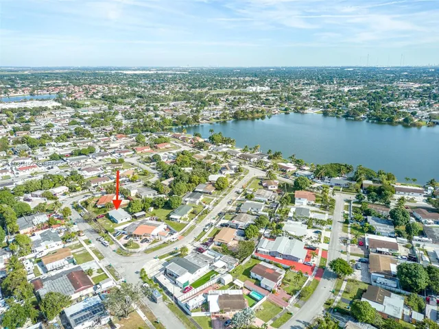 an aerial view of residential building and lake