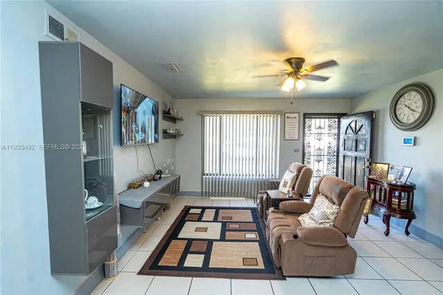 a living room with furniture a rug and a window