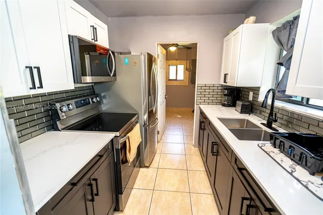 a kitchen that has a sink and a stove