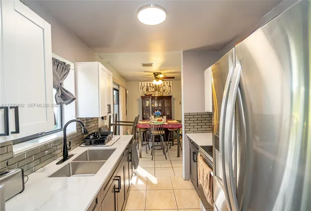 a dining room with furniture and a large window