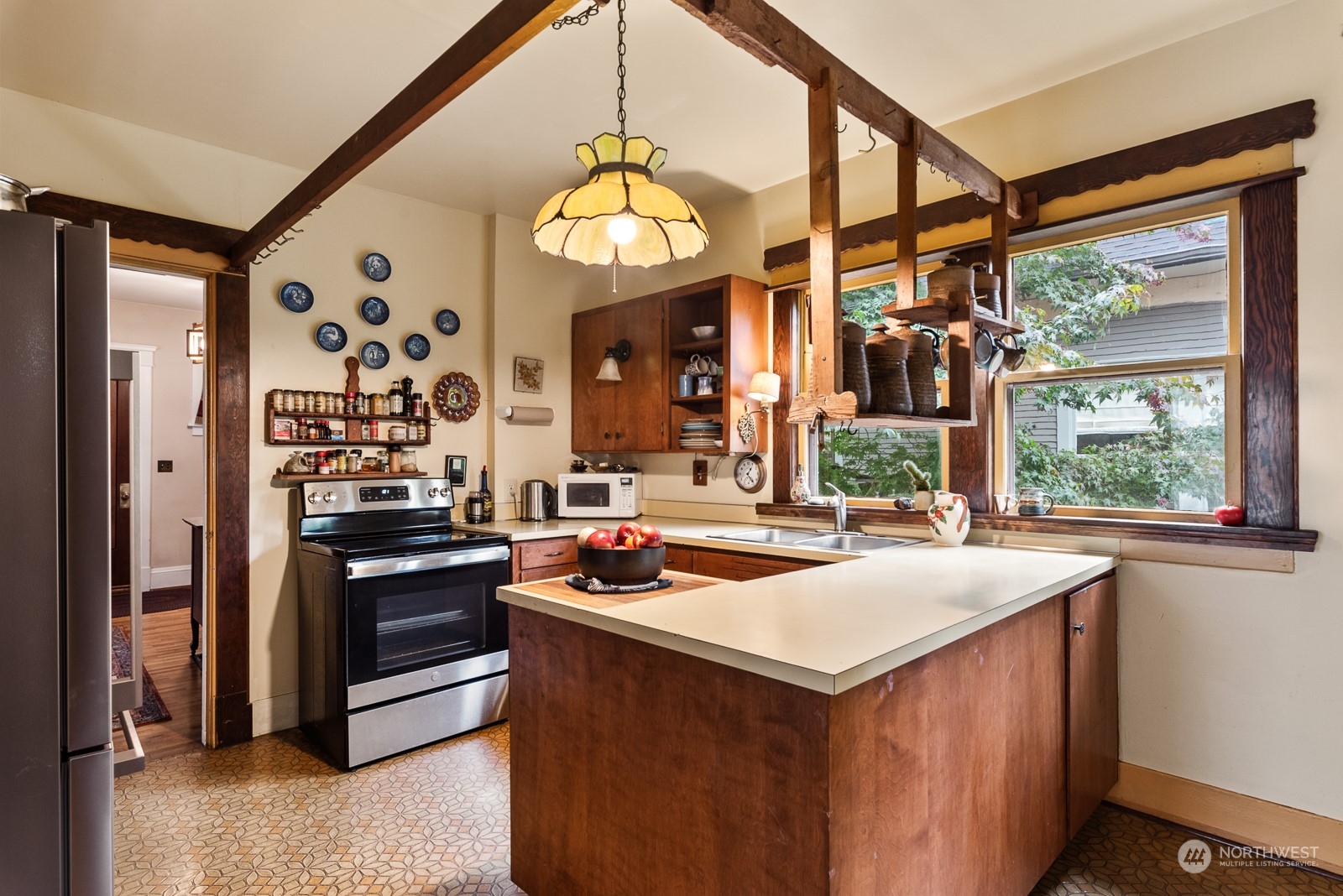 1211 Rucker Avenue Everett, WA 98201 - Photo 16 of 40 a kitchen with a stove a sink and a refrigerator