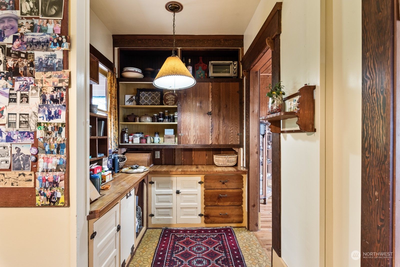 1211 Rucker Avenue Everett, WA 98201 - Photo 18 of 40 a hallway with cabinets and wooden floor