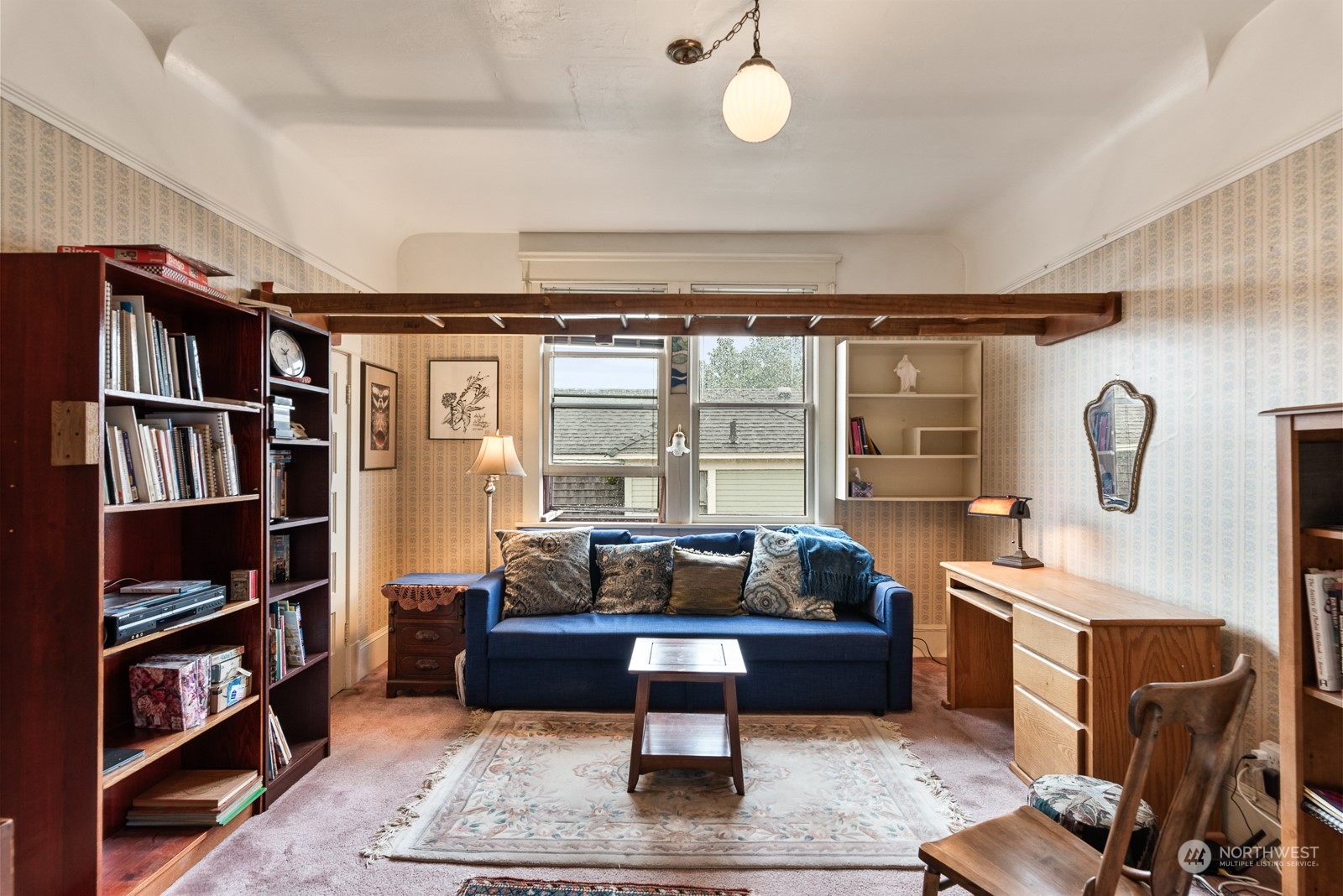1211 Rucker Avenue Everett, WA 98201 - Photo 29 of 40 a living room with furniture a rug and a book shelf