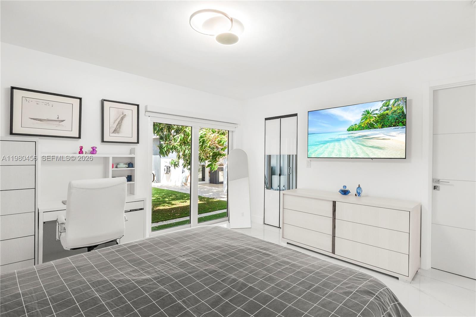 12401 Southwest 72nd Avenue Pinecrest, FL 33156 - Photo 11 of 35 a room with a baby crib and a window