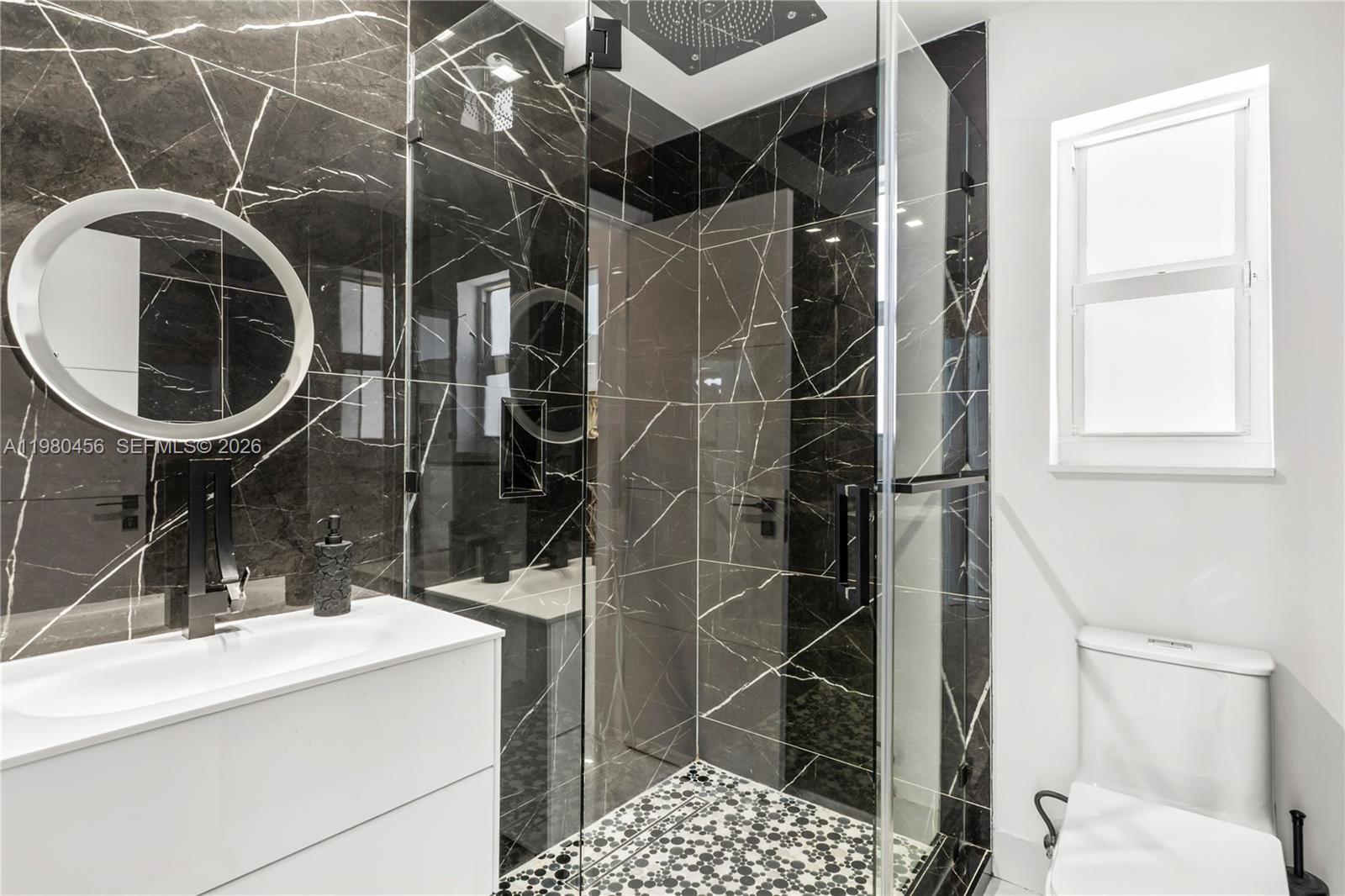 12401 Southwest 72nd Avenue Pinecrest, FL 33156 - Photo 12 of 35 a bathroom with a sink toilet and shower