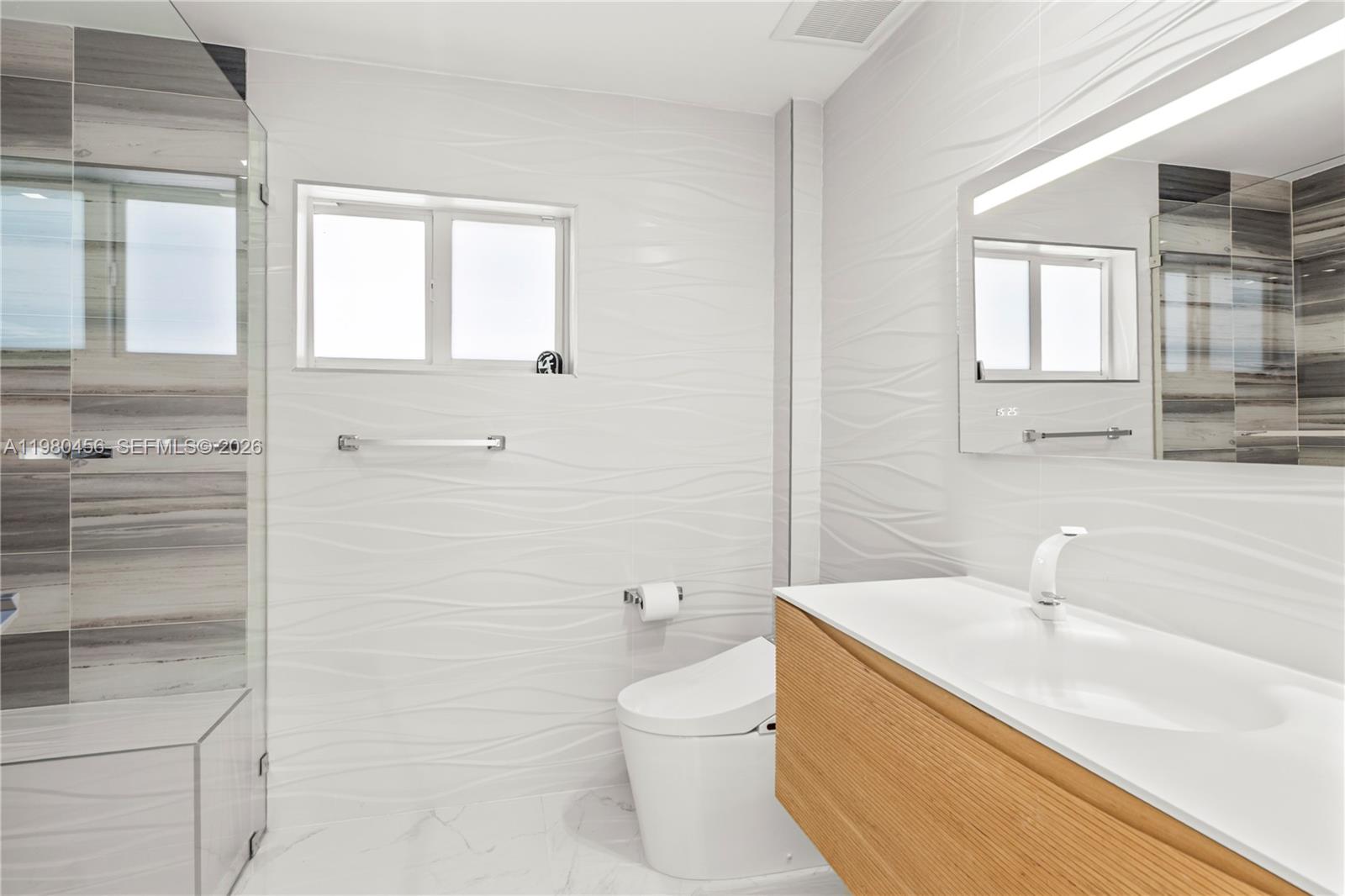 12401 Southwest 72nd Avenue Pinecrest, FL 33156 - Photo 16 of 35 a bathroom with a sink a toilet and shower