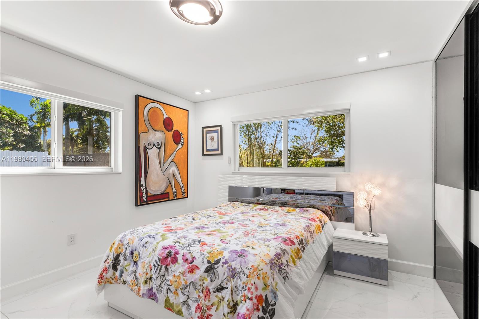 12401 Southwest 72nd Avenue Pinecrest, FL 33156 - Photo 18 of 35 a bedroom with a bed and a painting on the wall