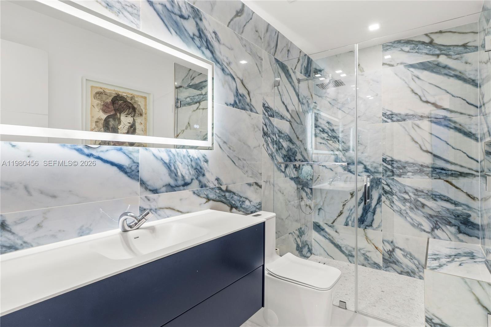 12401 Southwest 72nd Avenue Pinecrest, FL 33156 - Photo 19 of 35 a bathroom with a sink vanity mirror and toilet