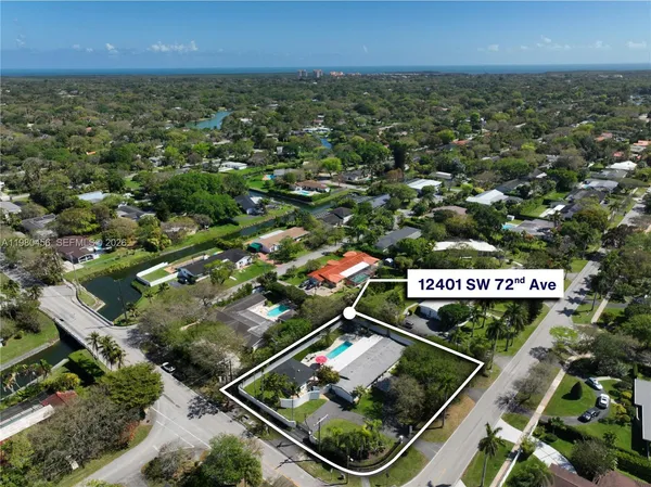 an aerial view of residential houses with outdoor space and street view