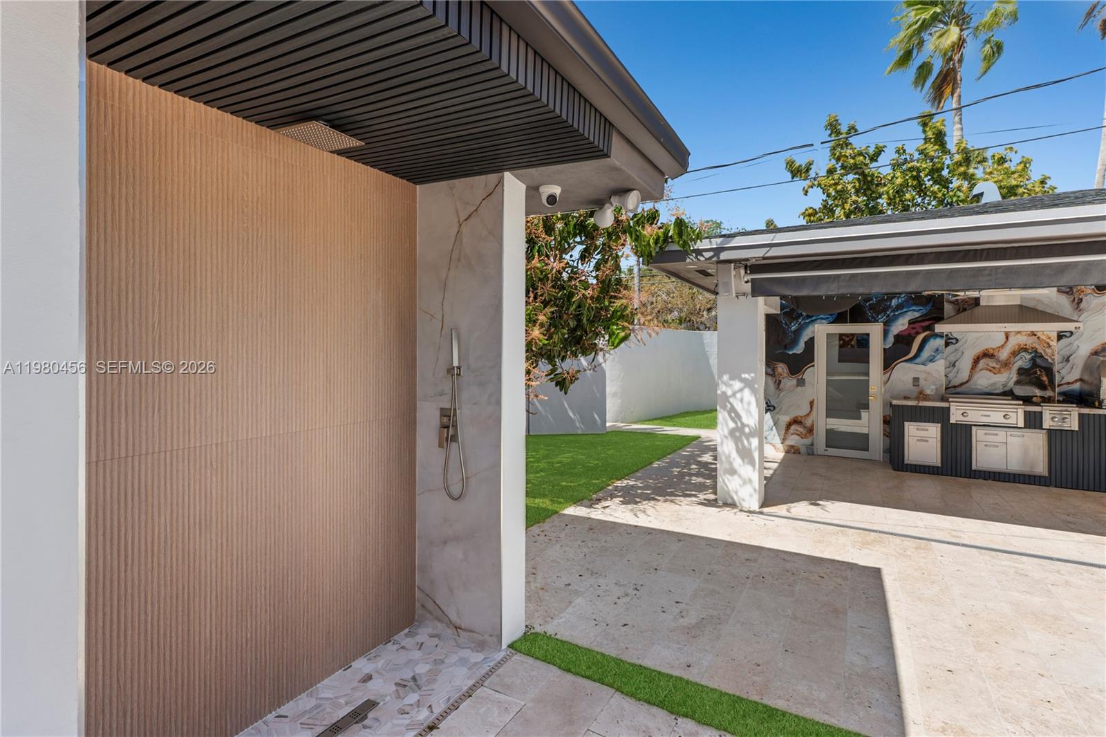 12401 Southwest 72nd Avenue Pinecrest, FL 33156 - Photo 23 of 35 a front view of a house with a porch and a table
