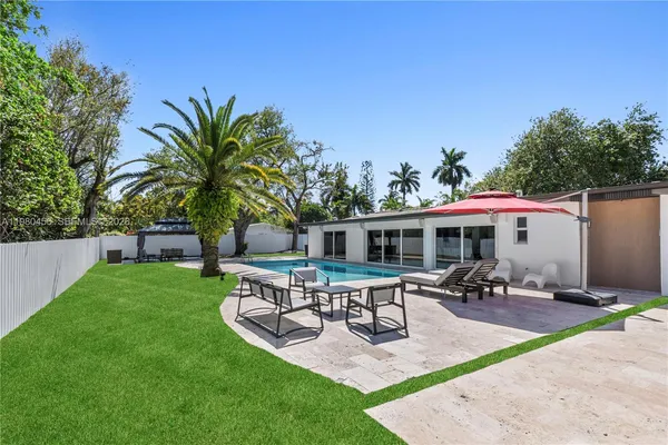 a view of a chairs and table in a patio