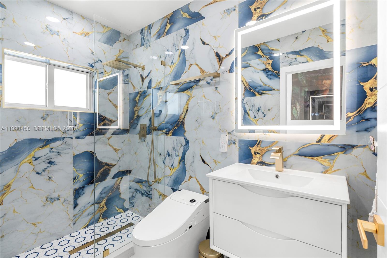 12401 Southwest 72nd Avenue Pinecrest, FL 33156 - Photo 27 of 35 a bathroom with a sink a toilet and shower