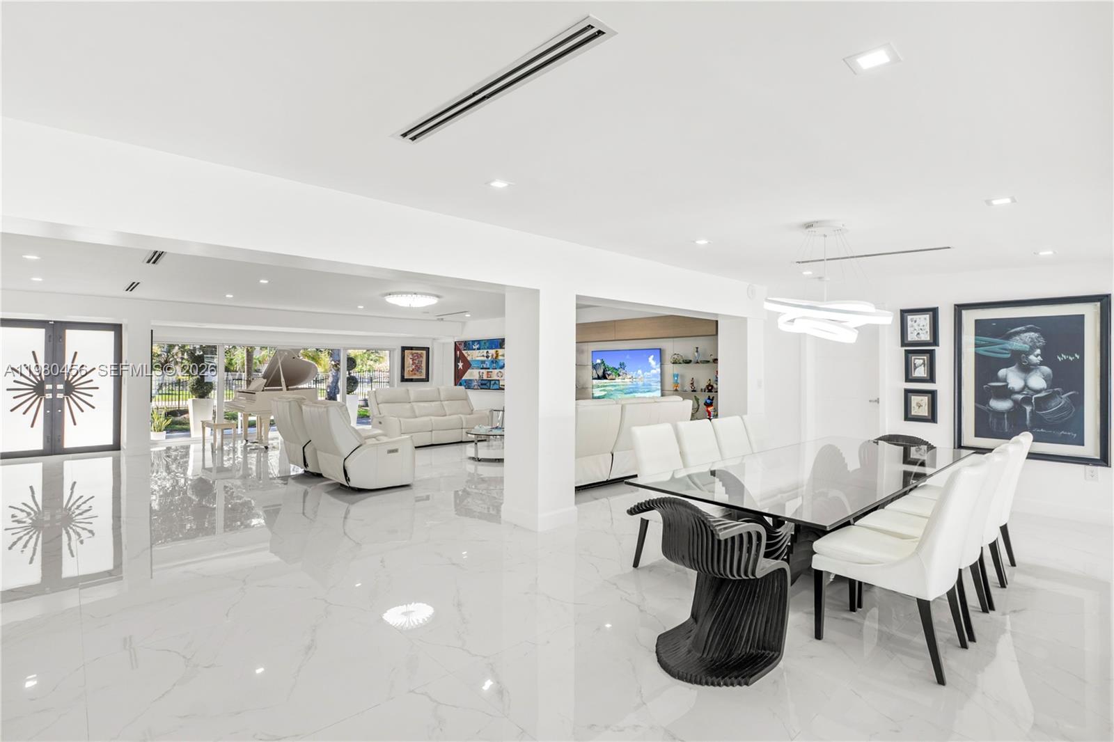 12401 Southwest 72nd Avenue Pinecrest, FL 33156 - Photo 3 of 35 a living room with furniture and a large window