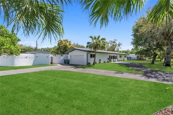 a view of a house with a yard and garage