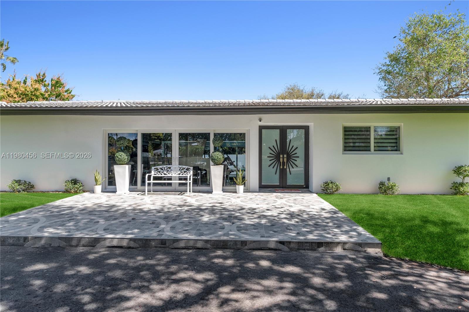 12401 Southwest 72nd Avenue Pinecrest, FL 33156 - Photo 33 of 35 a house with yard in front of it