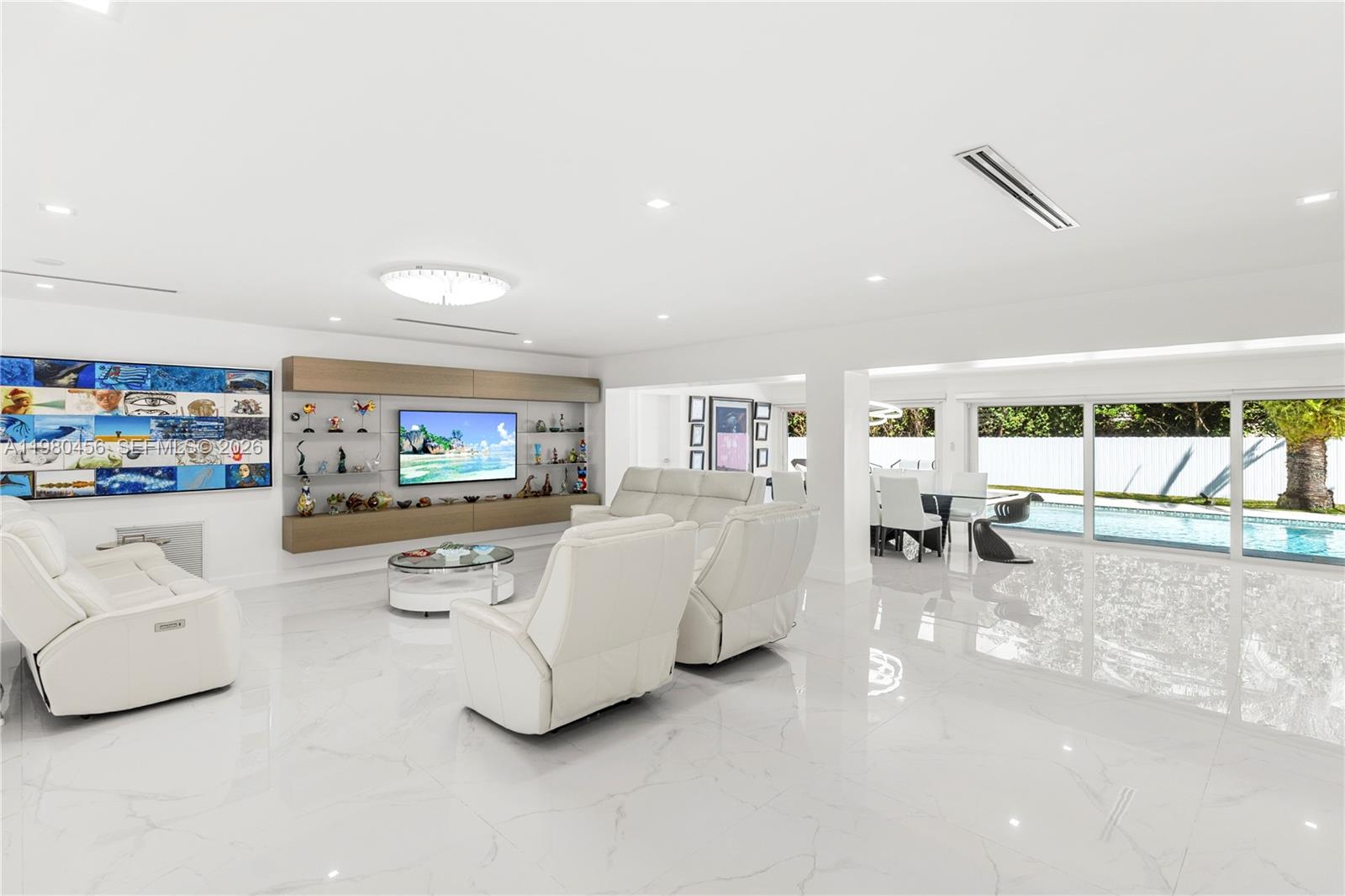 12401 Southwest 72nd Avenue Pinecrest, FL 33156 - Photo 4 of 35 a living room with furniture and a flat screen tv