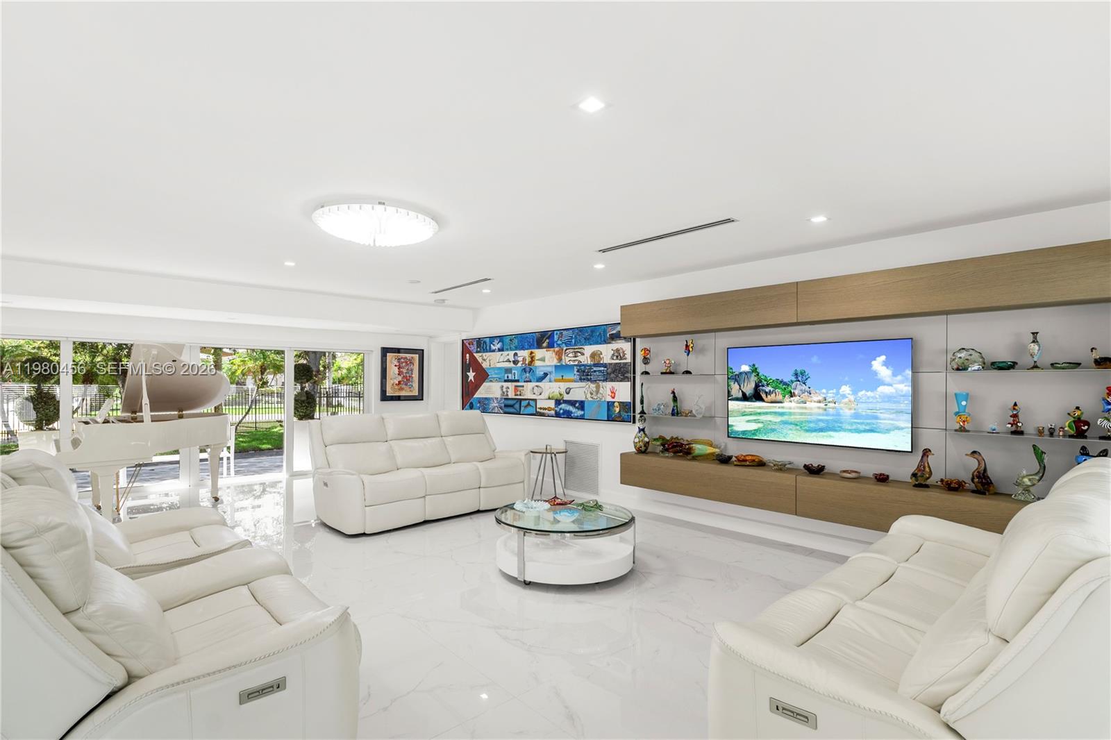 12401 Southwest 72nd Avenue Pinecrest, FL 33156 - Photo 5 of 35 a living room with furniture and a flat screen tv