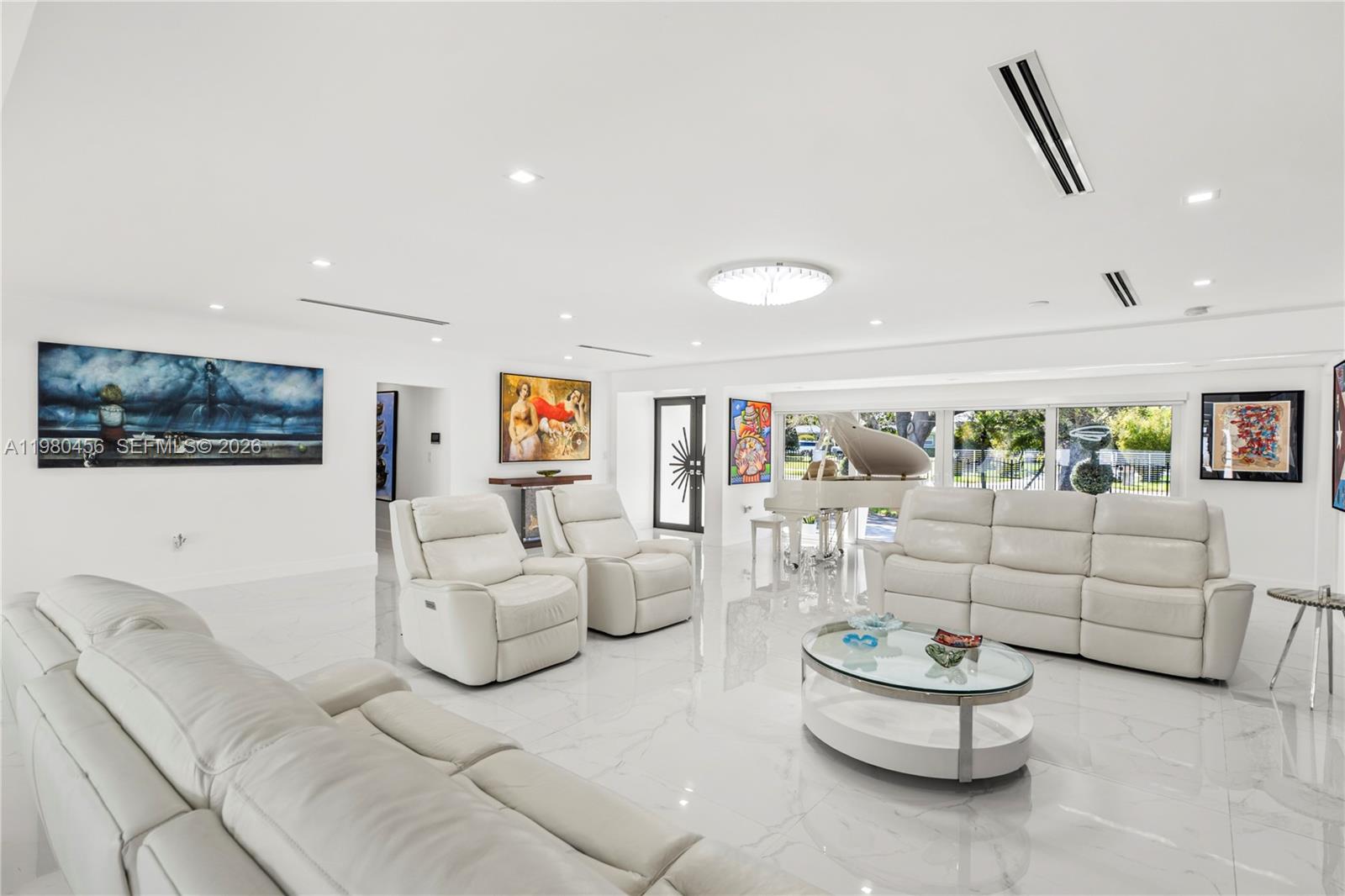 12401 Southwest 72nd Avenue Pinecrest, FL 33156 - Photo 6 of 35 a living room with furniture and a flat screen tv