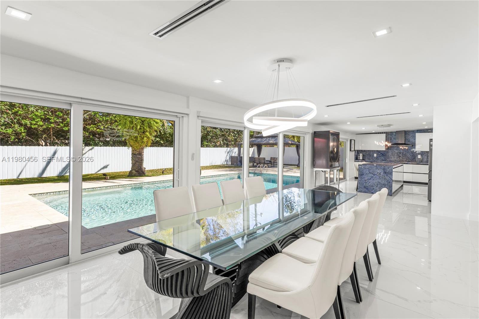 12401 Southwest 72nd Avenue Pinecrest, FL 33156 - Photo 7 of 35 a living room with furniture and a large window