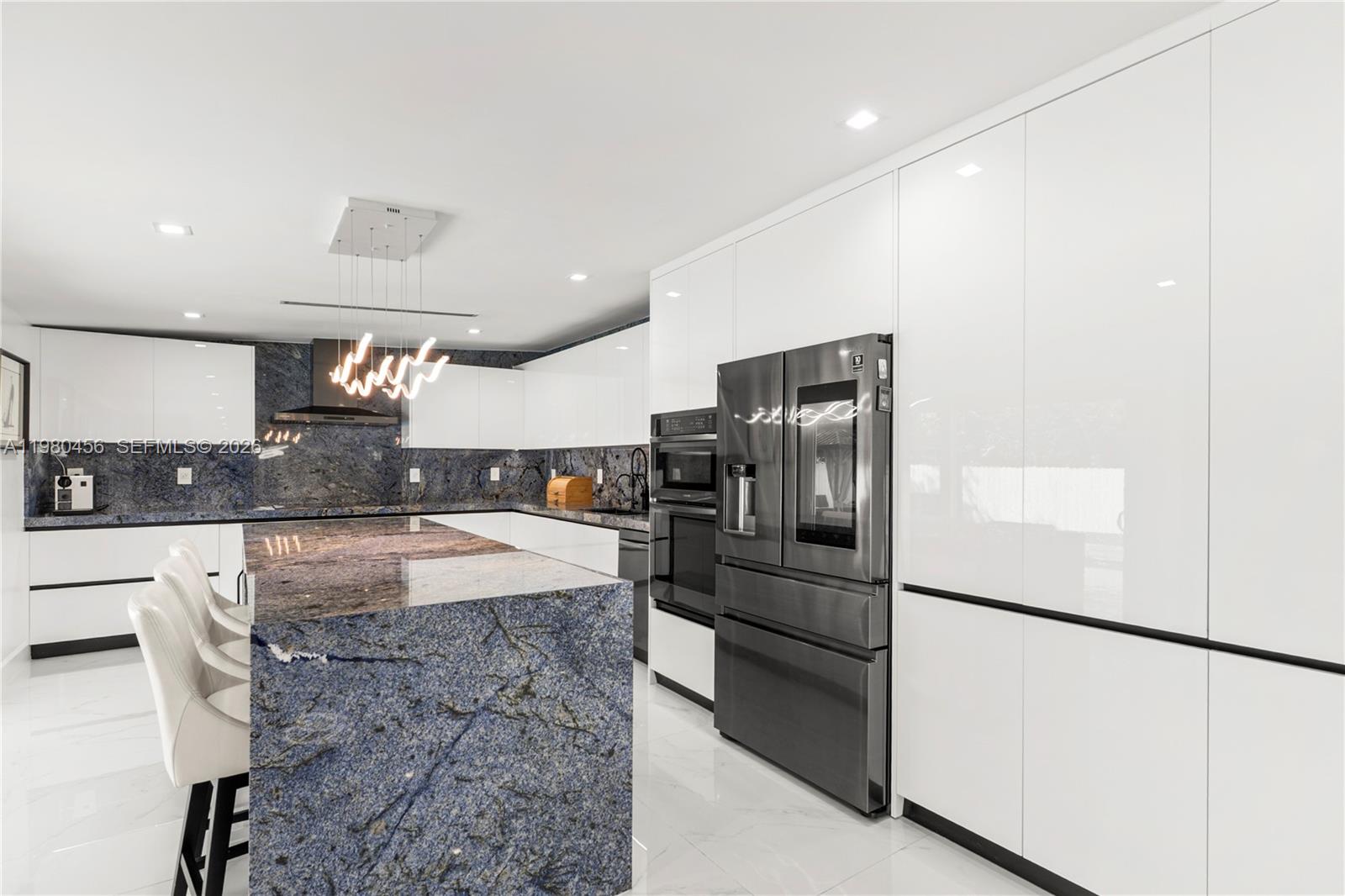 12401 Southwest 72nd Avenue Pinecrest, FL 33156 - Photo 9 of 35 a kitchen with stainless steel appliances granite countertop a refrigerator and a stove
