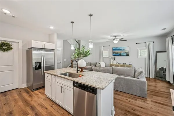 a kitchen with a sink a stove cabinets and appliances