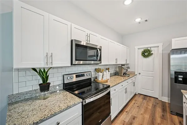 a kitchen with a sink stove and refrigerator