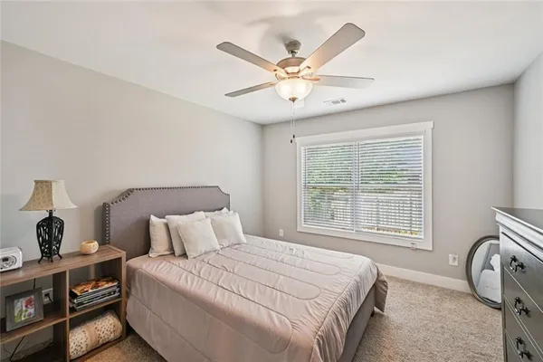 a bedroom with a bed and cabinets