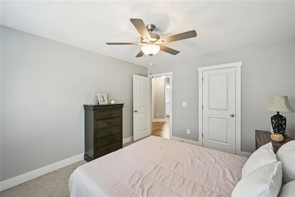 a bedroom with a large bed and a window