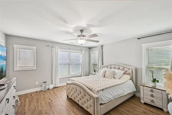 a bedroom with a bed and a chandelier