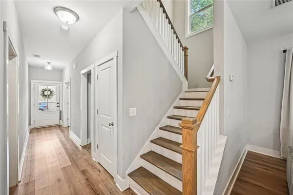 a view of a hallway with wooden floor and a window
