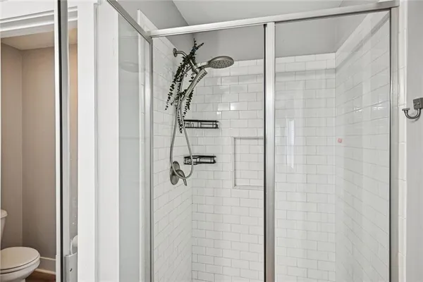 a bathroom with a granite countertop sink toilet and mirror