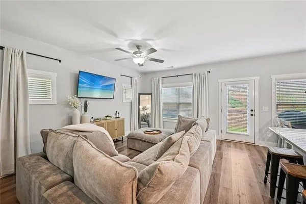 a living room with furniture and a wooden floor