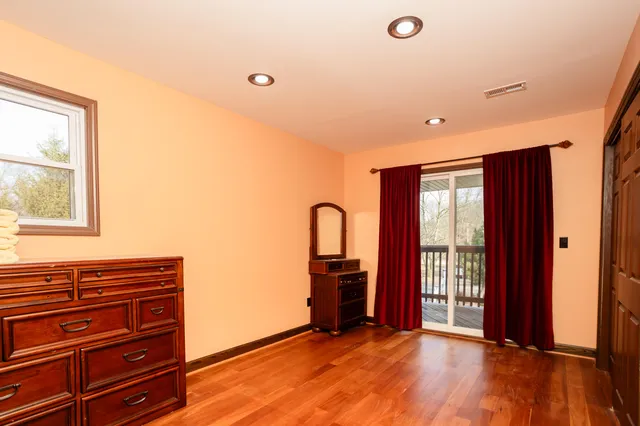 a view of a bedroom with furniture and window