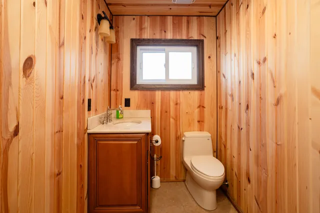 a bathroom with a toilet a sink and a shower curtain