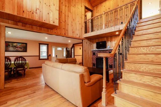 a living room with furniture a fireplace and a large window