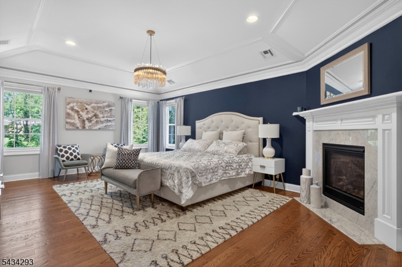 921 Harding Street Westfield, NJ 07090 - Photo 26 of 50 a bedroom with a large bed and a fireplace