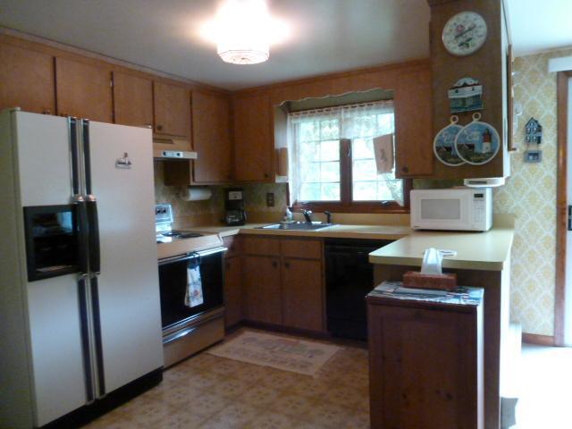 14 Captain Wing Road East Sandwich, MA 02537 - Photo 8 of 20 a kitchen with stainless steel appliances a stove a refrigerator a sink and a cabinets