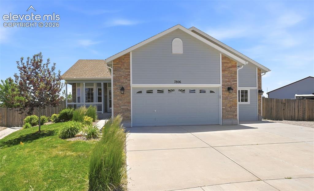 7806 Dutch Loop Colorado Springs, CO 80925 - Photo 1 of 41 a front view of a house with a garden