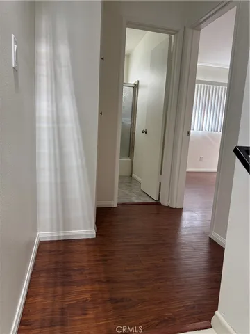 a view of a room with wooden floor and chair