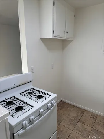 a stove top oven sitting inside of a kitchen