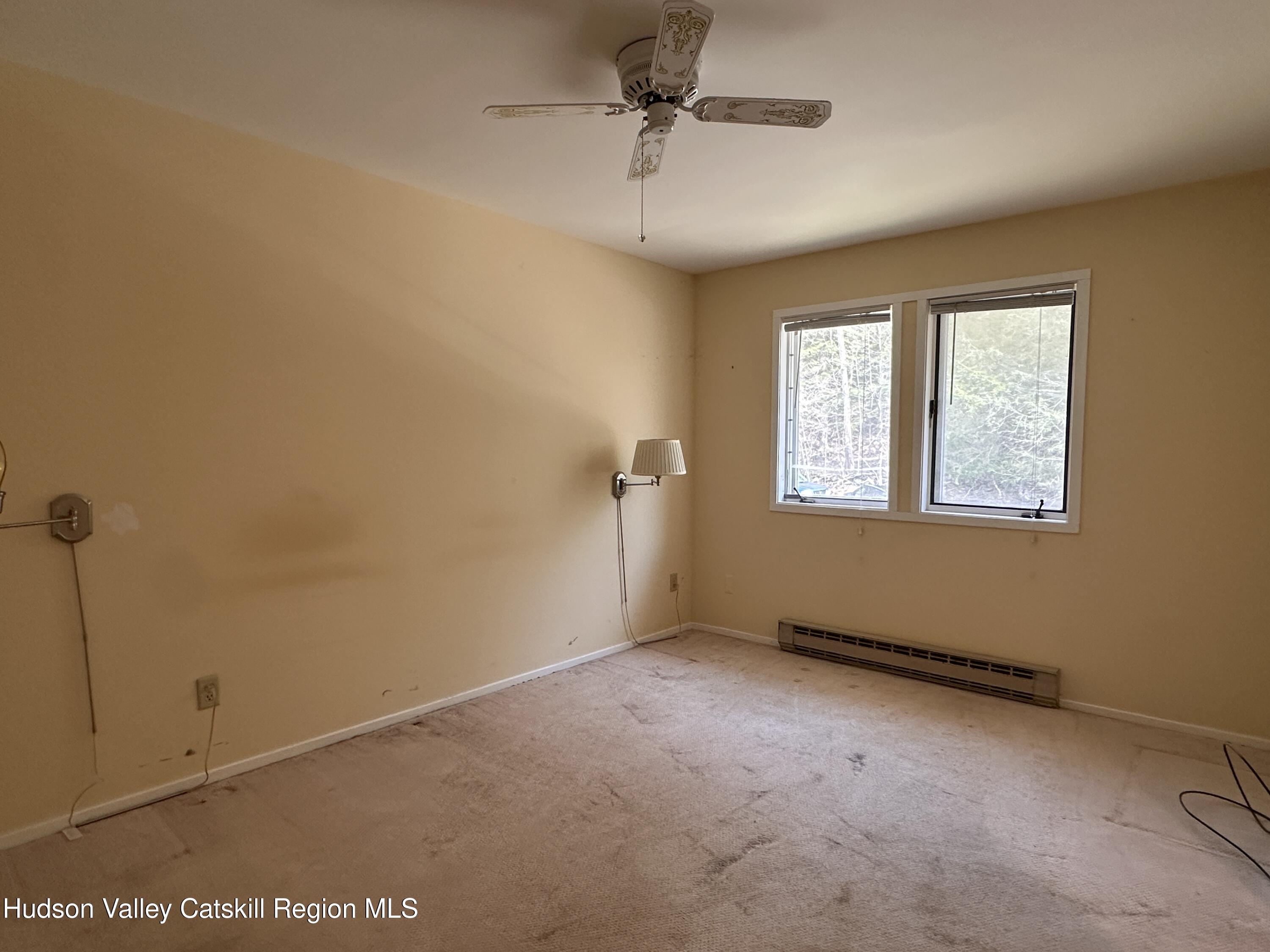 260 Pines Drive, Unit 82 Roxbury, NY 12421 - Photo 18 of 31 an empty room with windows and fan