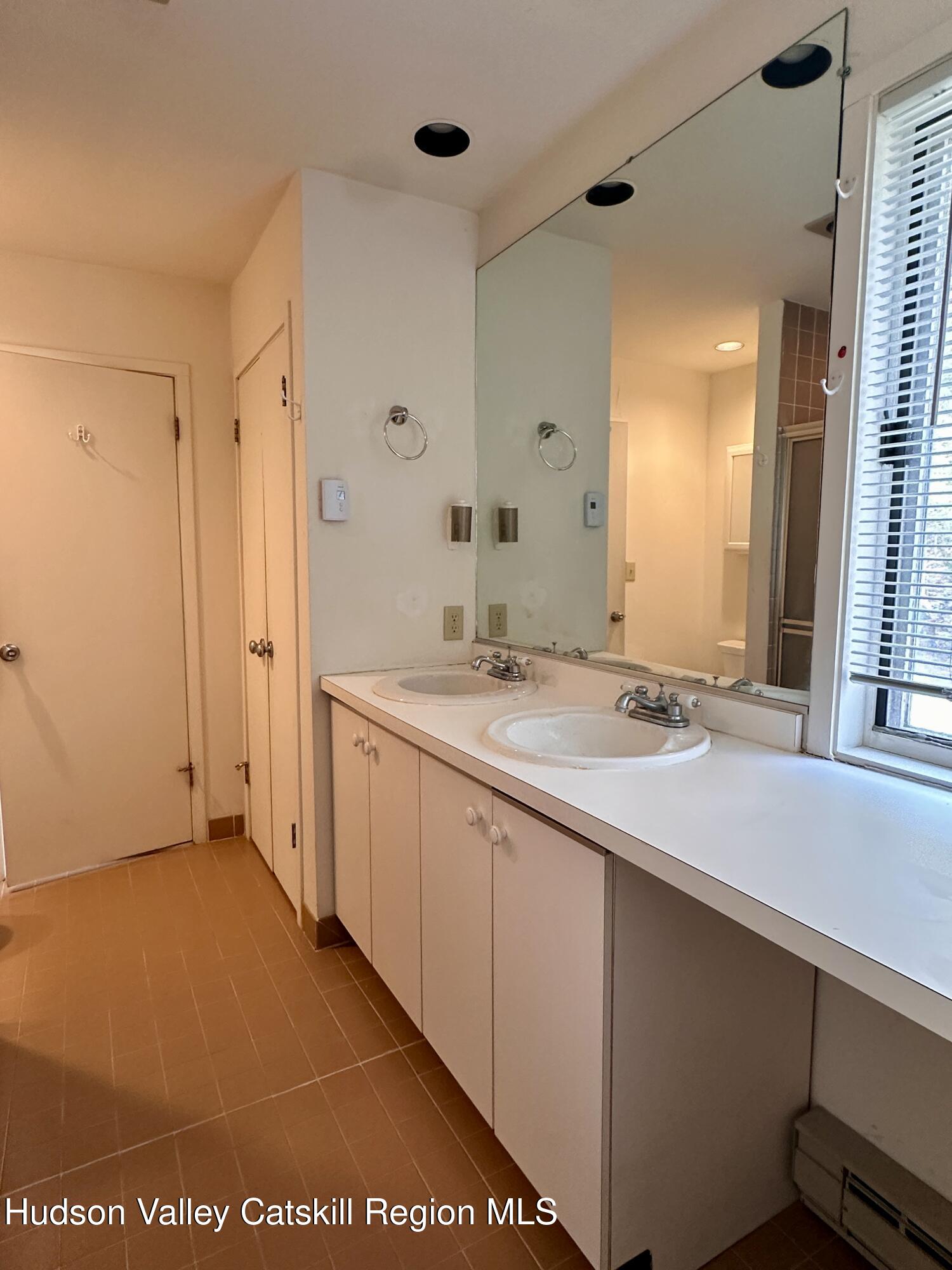 260 Pines Drive, Unit 82 Roxbury, NY 12421 - Photo 25 of 31 a bathroom with a sink and a mirror